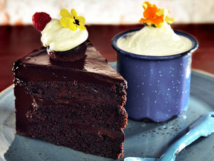 Pastel de chocolate oscuro con crema y frutos rojos